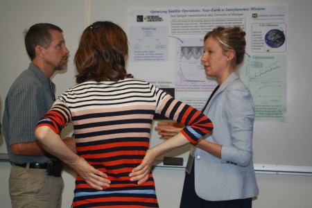 Sara Spangelo (right) explains her research